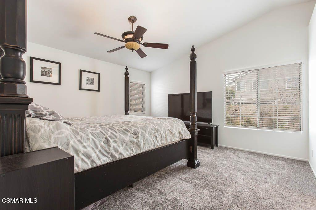1752 Empty Saddle Road Simi Valley, CA 93063 - Photo 22 of 34 a spacious bedroom with a bed and a flat screen tv