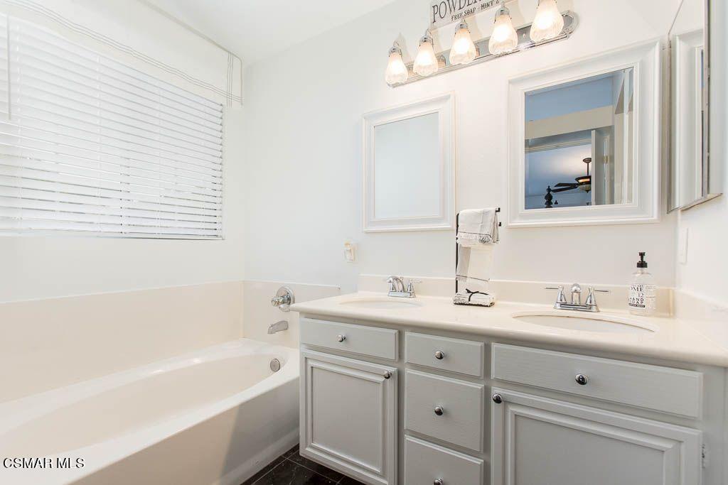 1752 Empty Saddle Road Simi Valley, CA 93063 - Photo 24 of 34 a bathroom with a tub double sink and mirror