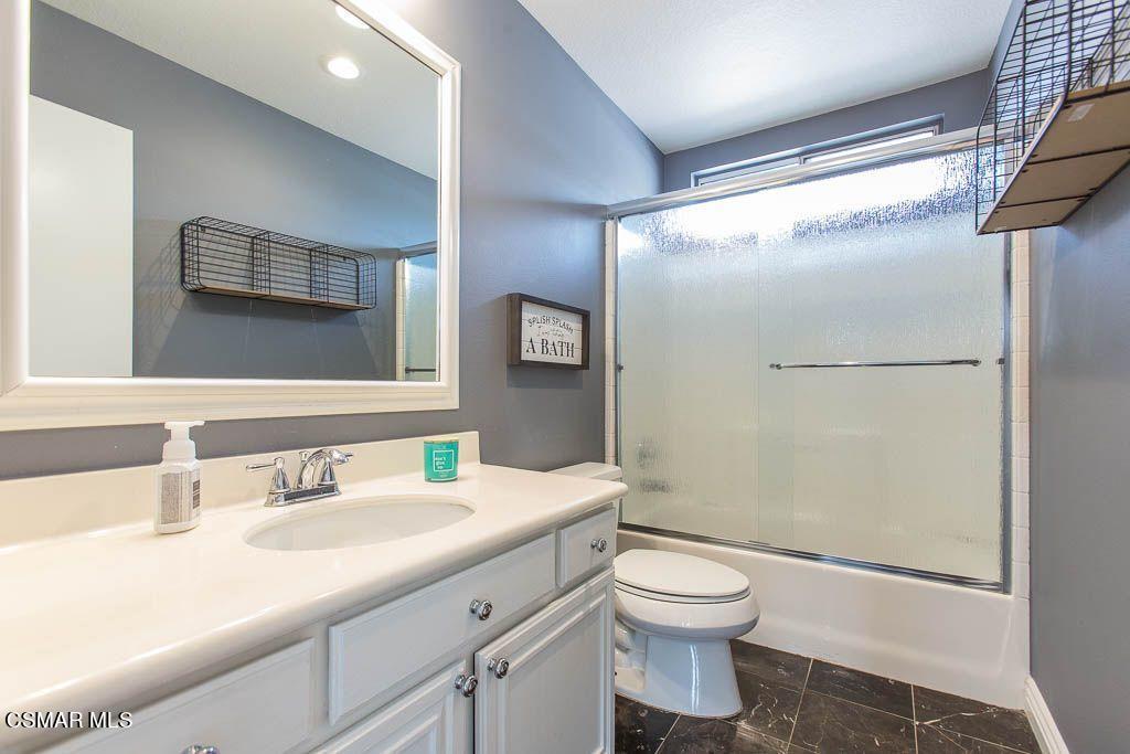 1752 Empty Saddle Road Simi Valley, CA 93063 - Photo 28 of 34 a bathroom with a granite countertop sink toilet a mirror and shower