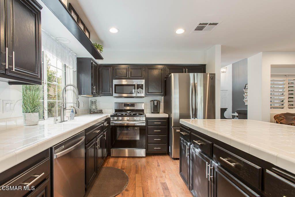 1752 Empty Saddle Road Simi Valley, CA 93063 - Photo 4 of 34 a kitchen with stainless steel appliances granite countertop a sink stove and refrigerator