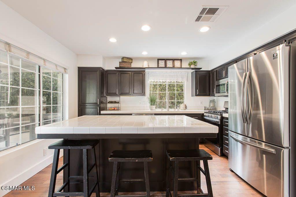 1752 Empty Saddle Road Simi Valley, CA 93063 - Photo 5 of 34 a kitchen with kitchen island a large window and stainless steel appliances