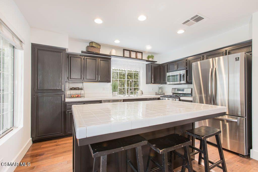 1752 Empty Saddle Road Simi Valley, CA 93063 - Photo 6 of 34 a kitchen with stainless steel appliances a refrigerator and a stove top oven