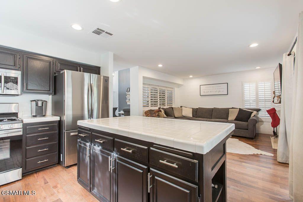 1752 Empty Saddle Road Simi Valley, CA 93063 - Photo 7 of 34 a large kitchen with stainless steel appliances granite countertop a lot of counter space and wooden floors