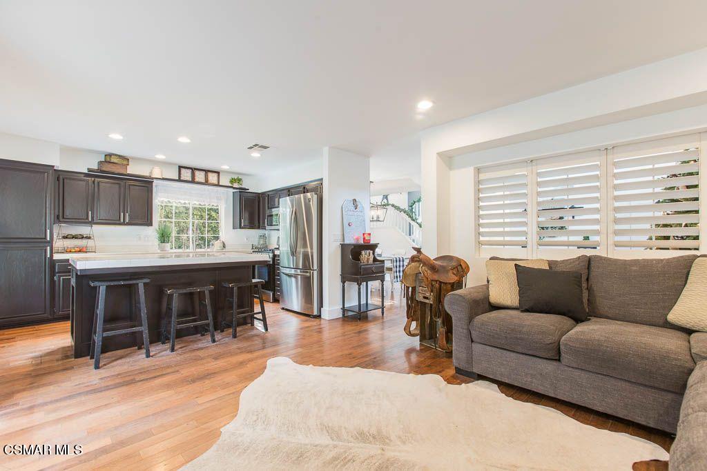 1752 Empty Saddle Road Simi Valley, CA 93063 - Photo 9 of 34 a living room with furniture a wooden floor and a large window