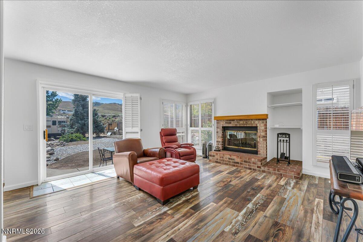 10 Eagle Claw Court Reno, NV 89523 - Photo 12 of 36 a living room with furniture a fireplace and a floor to ceiling window