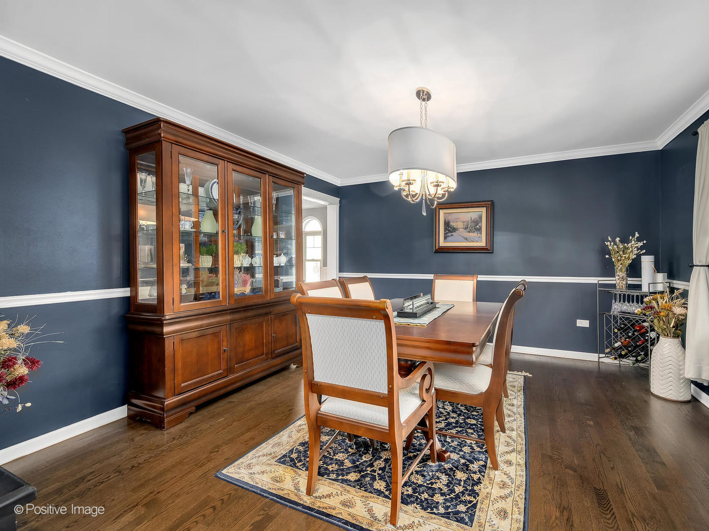 N252 Pleasant Hill Road Winfield, IL 60190 - Photo 5 of 32 a dining room with wooden floor a chandelier a wooden table and chairs