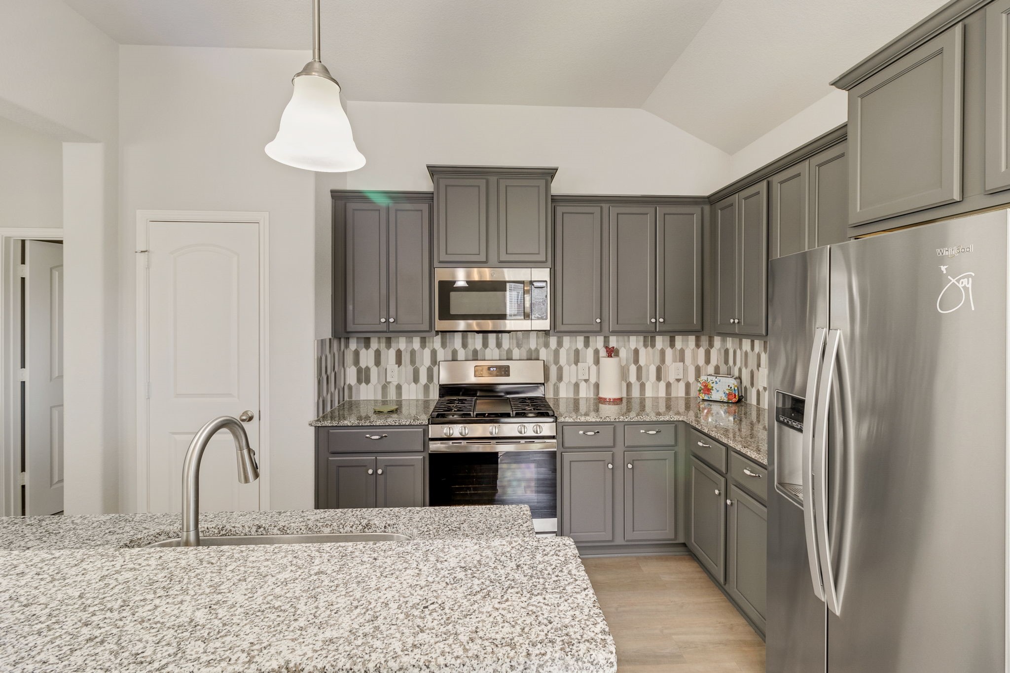 20232 Torrey Pines Lane Cleveland, TX 77327 - Photo 13 of 33 a kitchen with stainless steel appliances granite countertop a refrigerator sink and cabinets