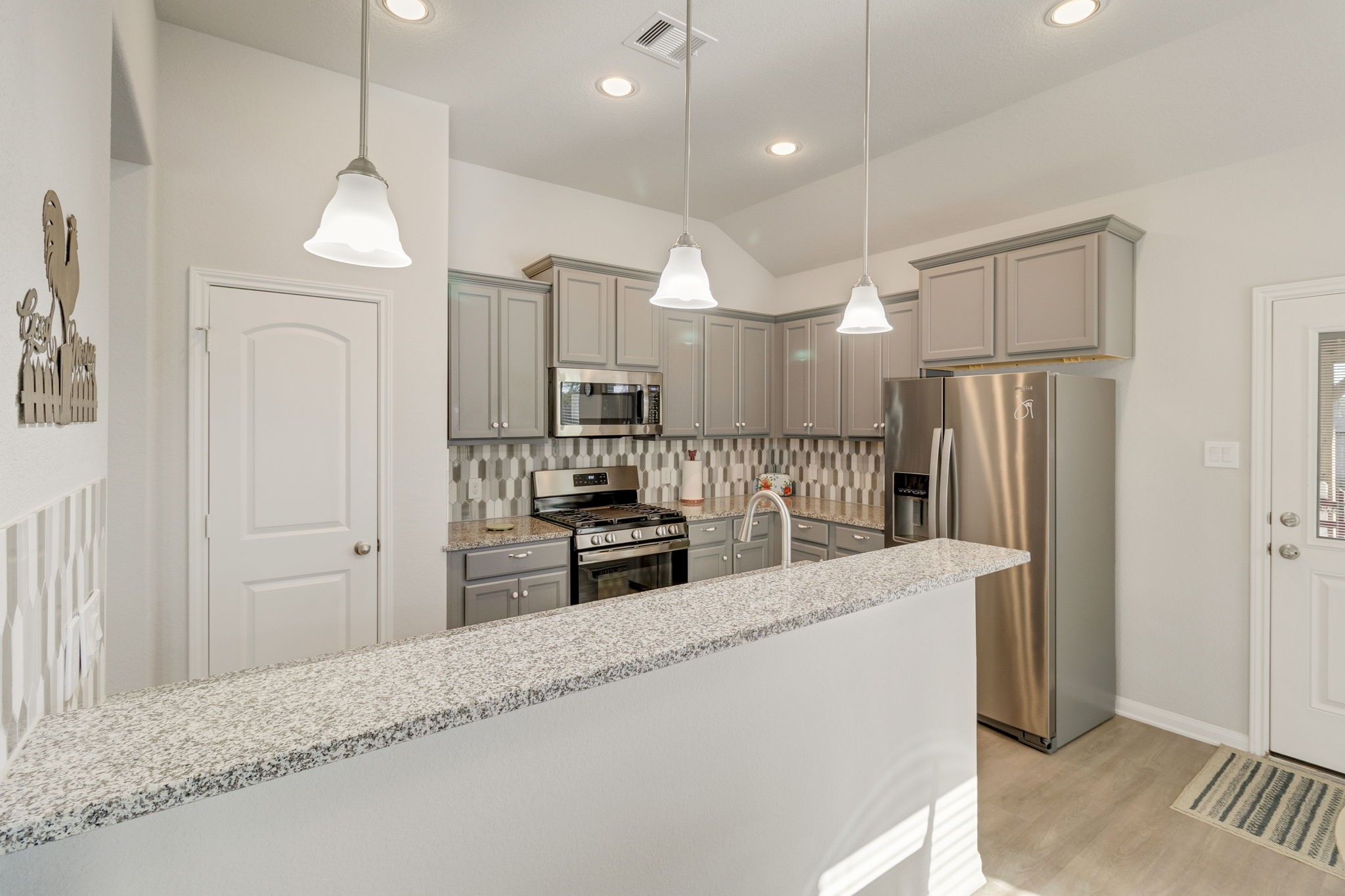 20232 Torrey Pines Lane Cleveland, TX 77327 - Photo 14 of 33 a kitchen with stainless steel appliances granite countertop a refrigerator a oven a sink a stove and a refrigerator with wooden floor