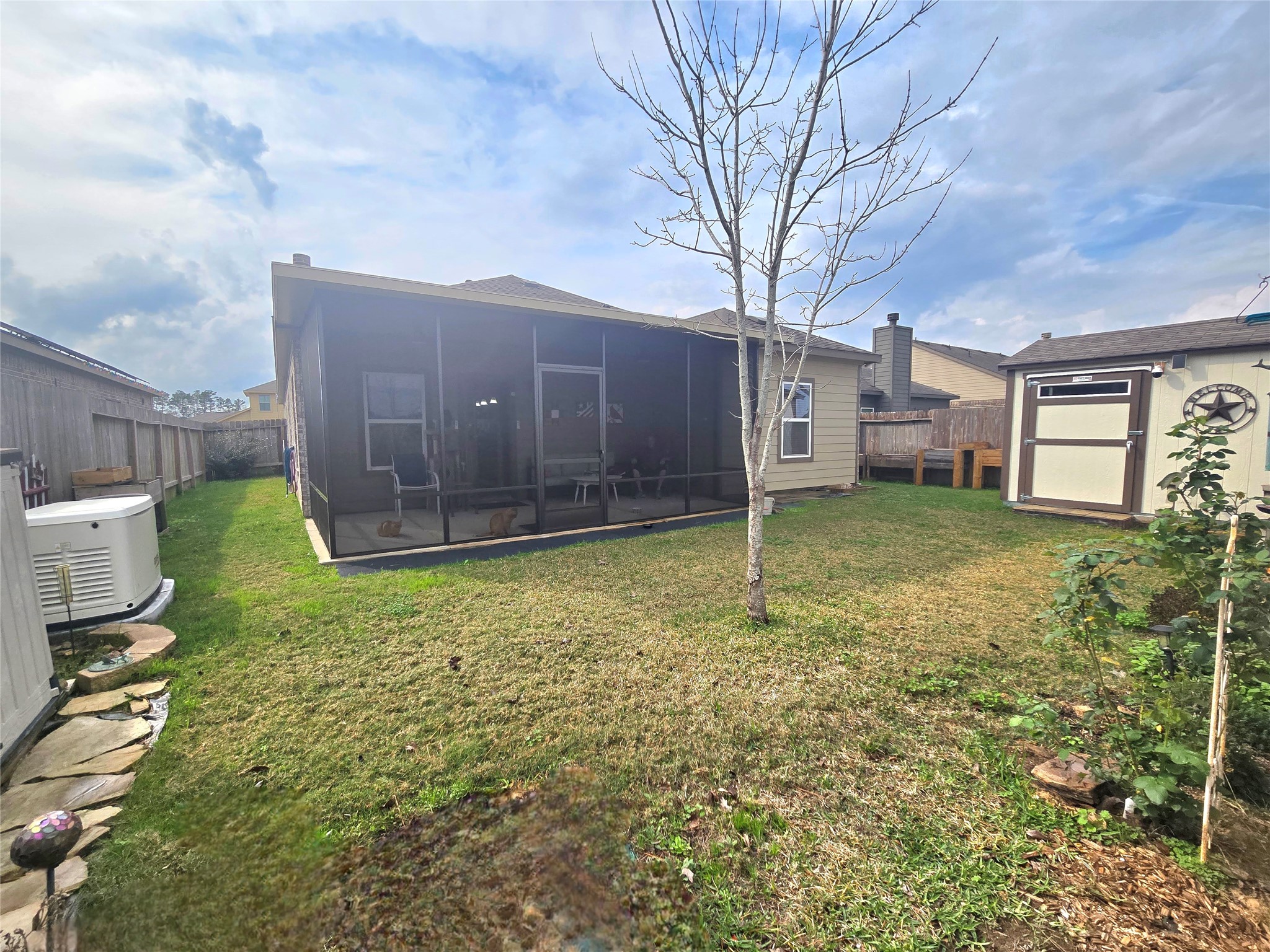 20232 Torrey Pines Lane Cleveland, TX 77327 - Photo 23 of 30 Expansive and beautifully landscaped Yard with Storage Shed, Raised Garden Beds, Storage Box & recently expanded and screened-in Patio