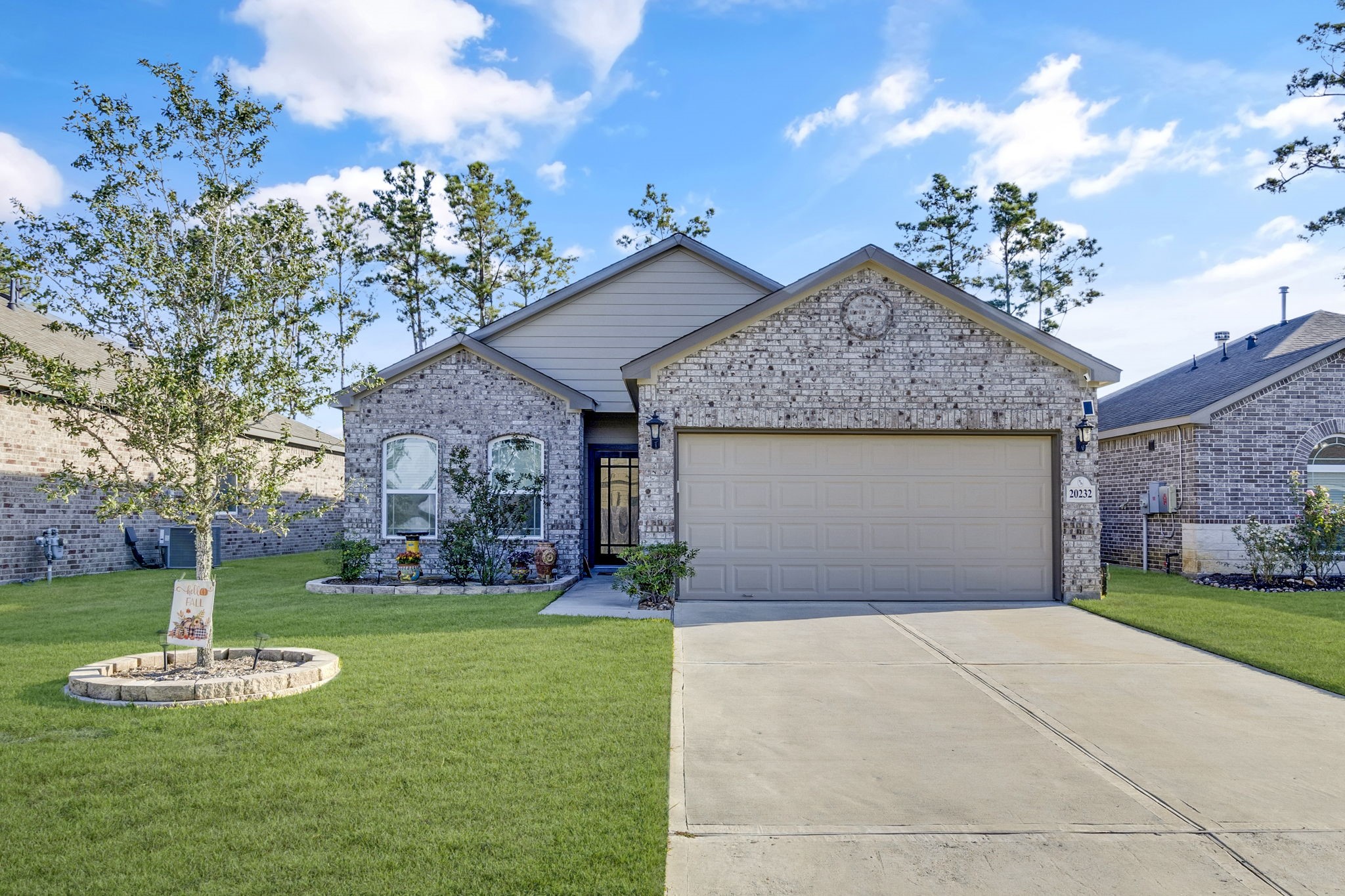 20232 Torrey Pines Lane Cleveland, TX 77327 - Photo 32 of 33 a front view of a house with a yard and garage