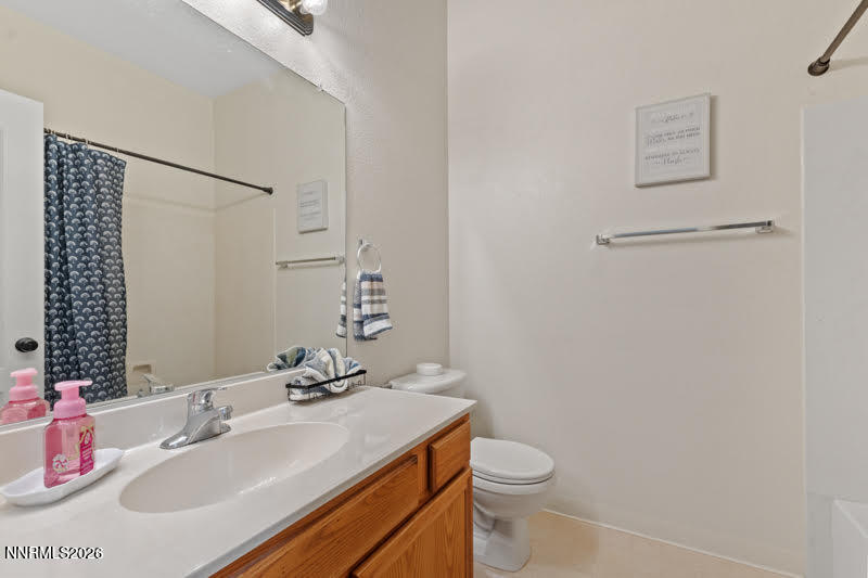 10025 Hampton Park Drive Reno, NV 89521 - Photo 7 of 16 a bathroom with a sink toilet and vanity
