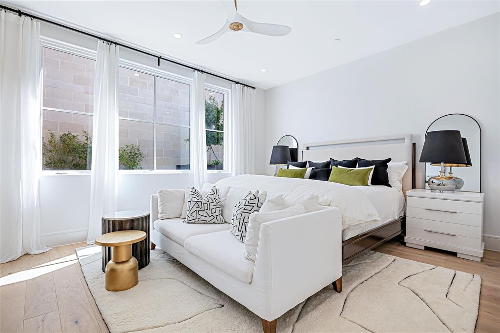 350 O O Connor Ridge Boulevard, Unit 13 Irving, TX 75038 - Photo 20 of 36 Spacious owners retreat with an inviting sitting area and expansive windows creating a bright, airy ambiance!(Photo of model showroom)