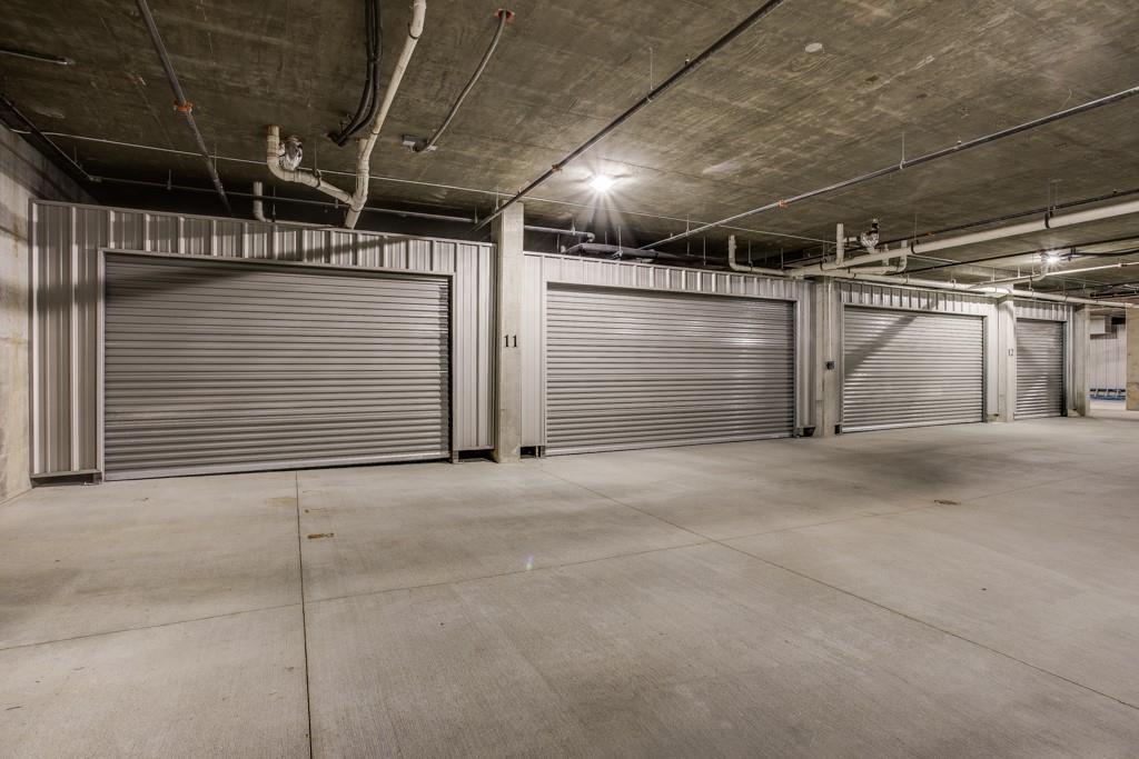 350 O O Connor Ridge Boulevard, Unit 13 Irving, TX 75038 - Photo 31 of 36 Secured access garages with individually enclosed spaces with plenty of space for two vehicles AND the golf cart!