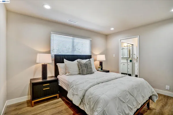 a bedroom with a bed and wooden floor