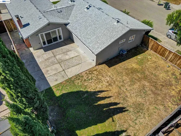 an aerial view of a house with a yard