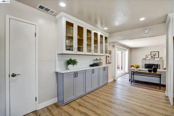 a kitchen with granite countertop cabinets and wooden floor