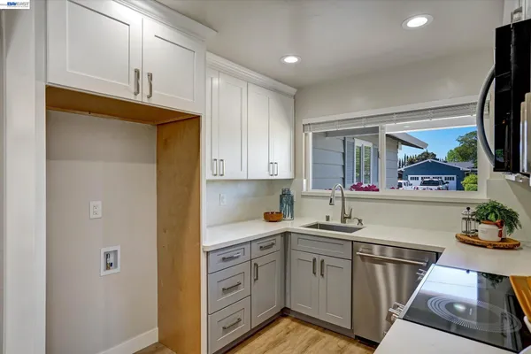 a kitchen with stainless steel appliances granite countertop a sink and a stove