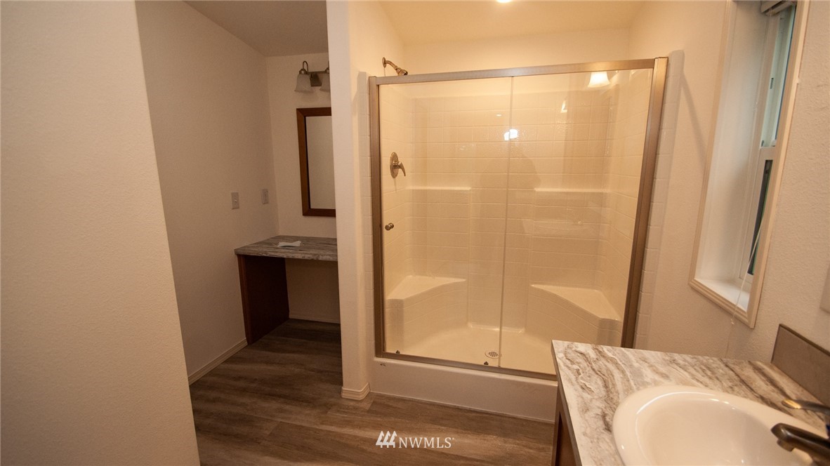 1111 Northeast Hurd Road Belfair, WA 98528 - Photo 24 of 29 a bathroom with a granite countertop sink and a mirror