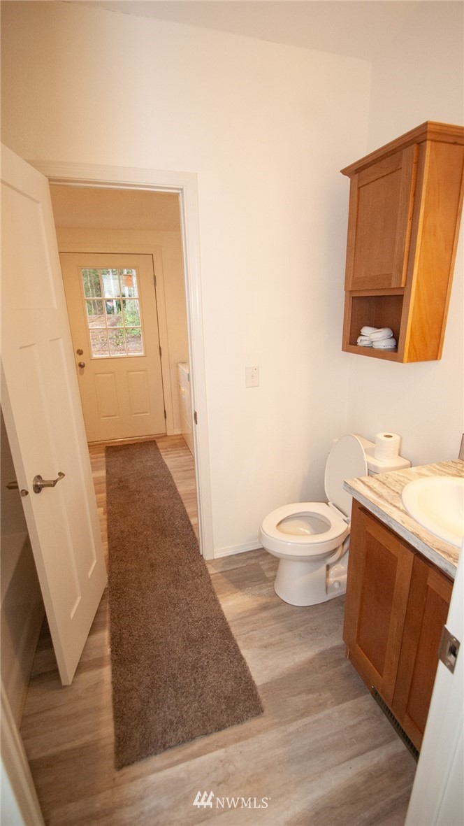 1111 Northeast Hurd Road Belfair, WA 98528 - Photo 28 of 29 a bathroom with a toilet sink and mirror