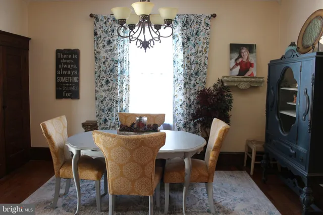 a view of a dining room with furniture and chandelier