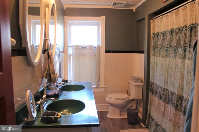 a bathroom with a toilet a sink and a mirror