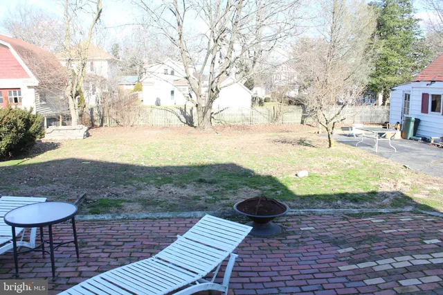 a view of yard with wooden deck and a backyard