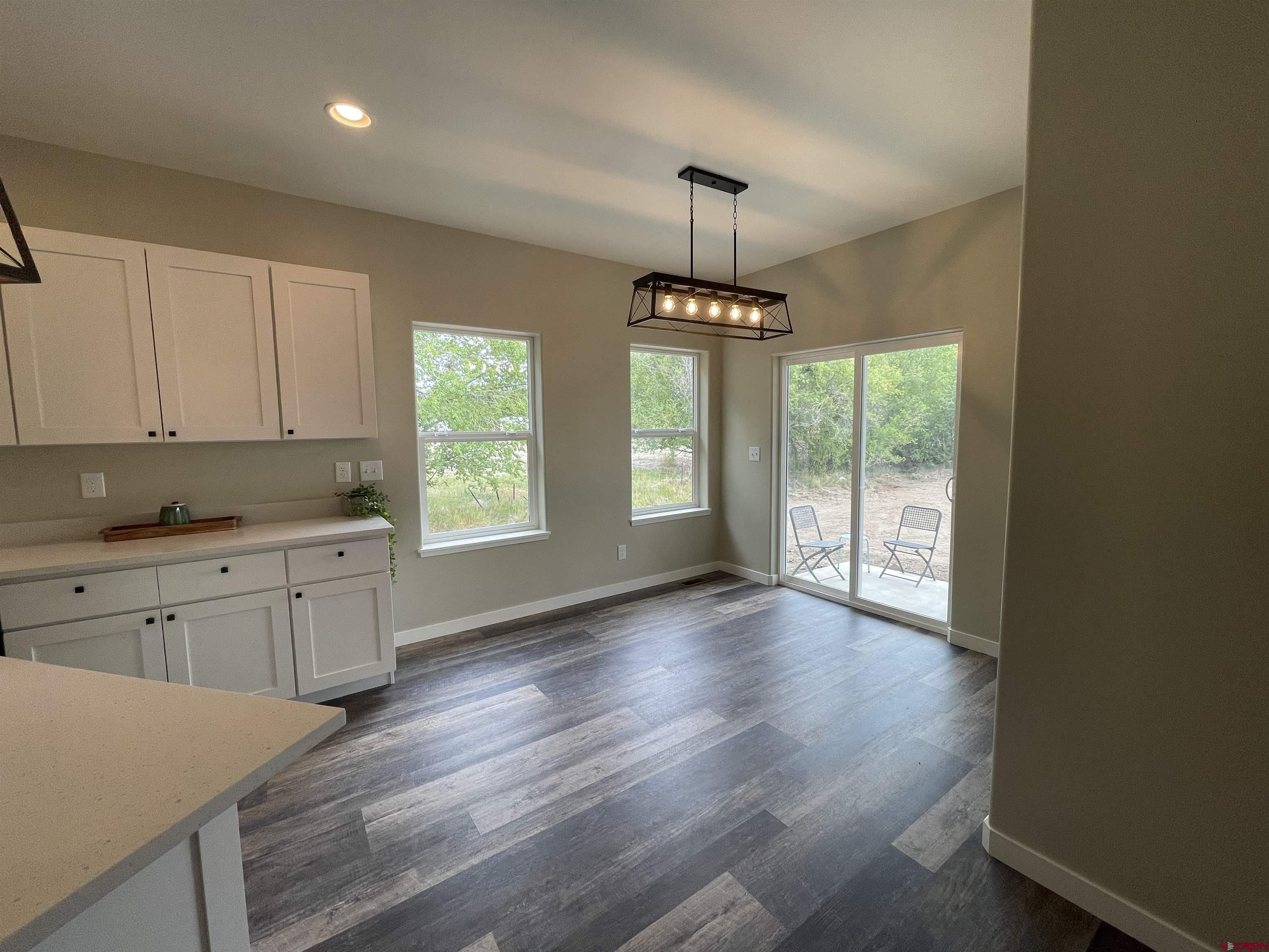 471 River Valley Court Delta, CO 81416 - Photo 12 of 31 a kitchen with stainless steel appliances granite countertop white cabinets and window