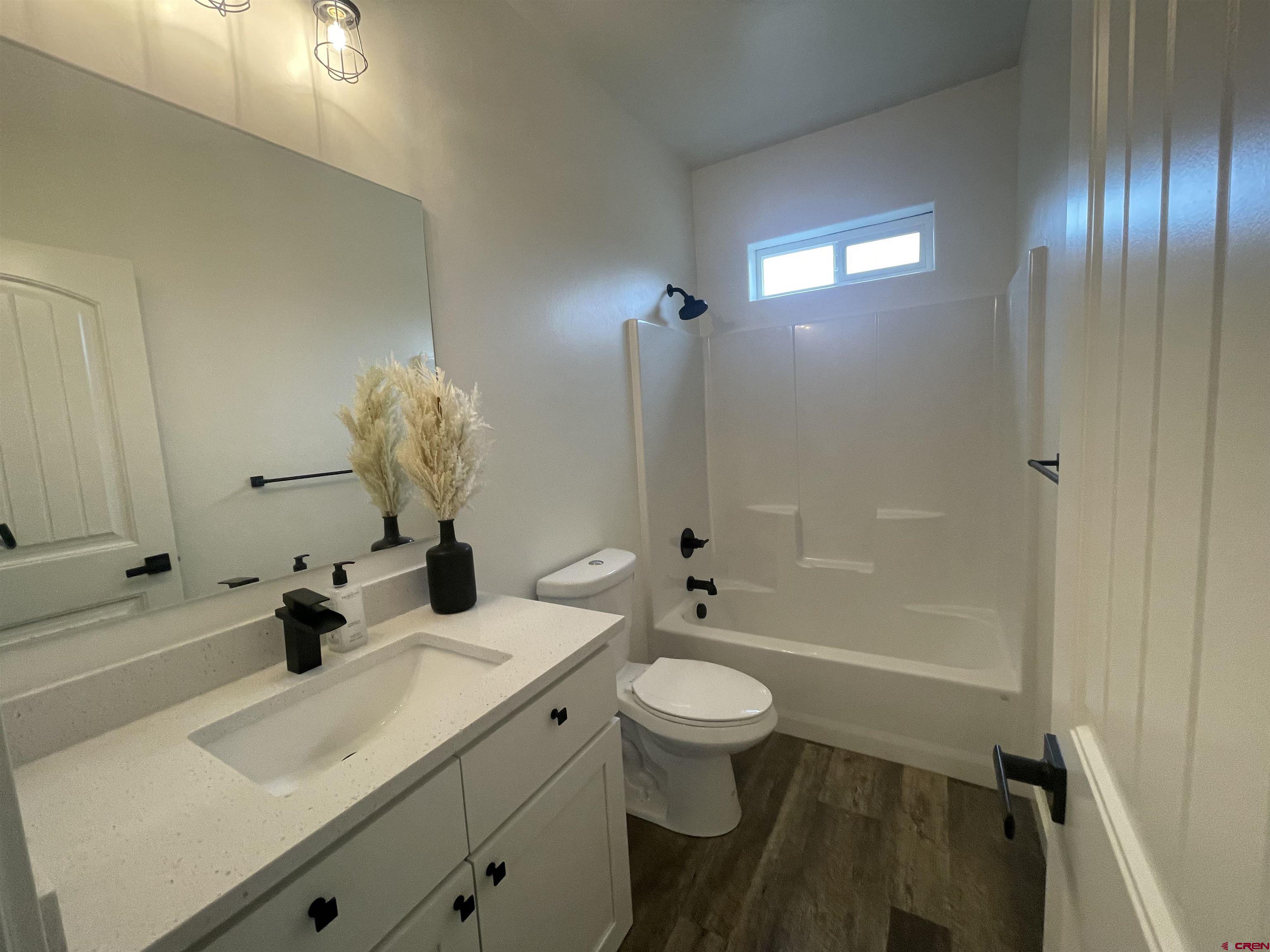 471 River Valley Court Delta, CO 81416 - Photo 22 of 31 a bathroom with a sink a toilet and shower