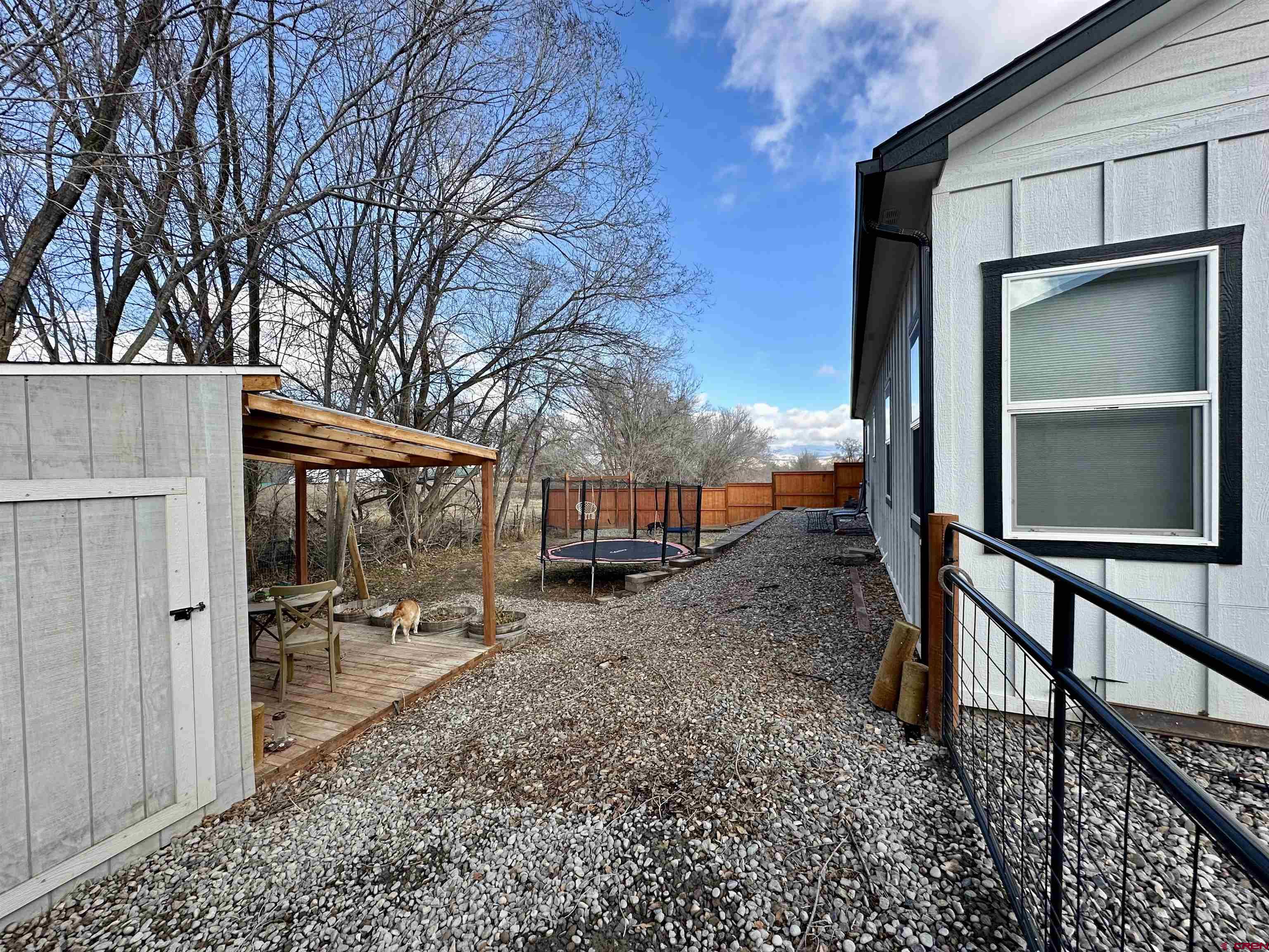 471 River Valley Court Delta, CO 81416 - Photo 28 of 31 a backyard of a house with barbeque oven table and chairs
