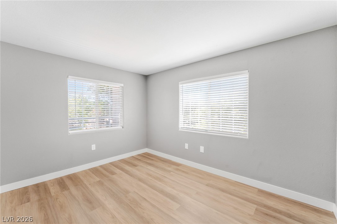 3318 North Decatur Boulevard, Unit 2152 Las Vegas, NV 89130 - Photo 24 of 58 Blonde hardwood floors flow through this naturally illuminated, versatile room, perfect for any use.