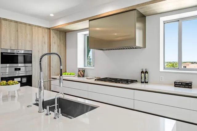 a kitchen with a sink cabinets and appliances