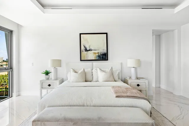 a large white bed in a white room