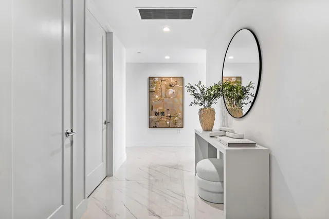 a view of a hallway with paintings on the wall