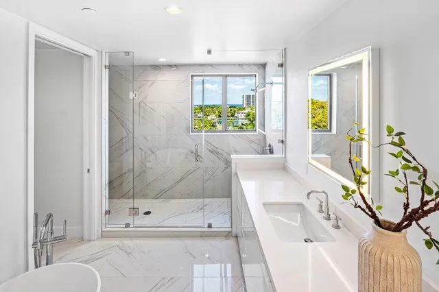 a bathroom with a tub sink and mirror