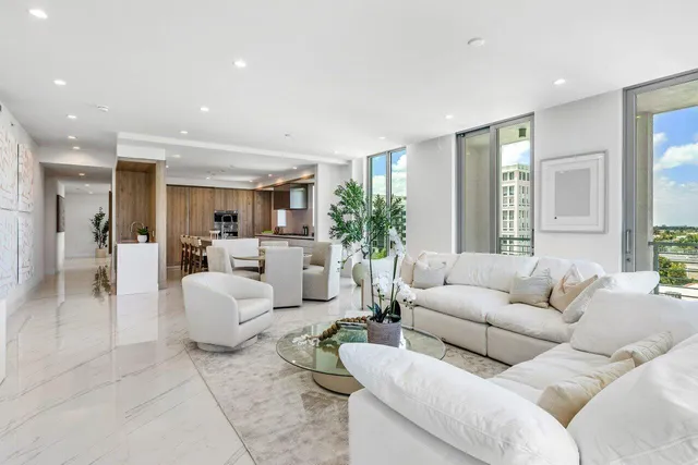 a living room with furniture and view of kitchen