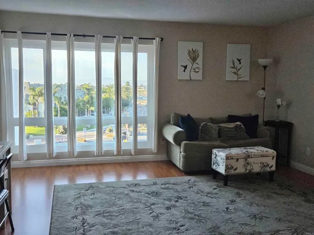 a living room with furniture and a floor to ceiling window