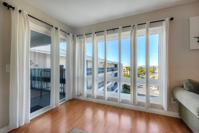a view of room with window and wooden floor