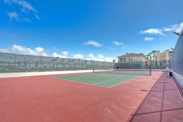 a view of a patio with a table and chairs under an umbrella