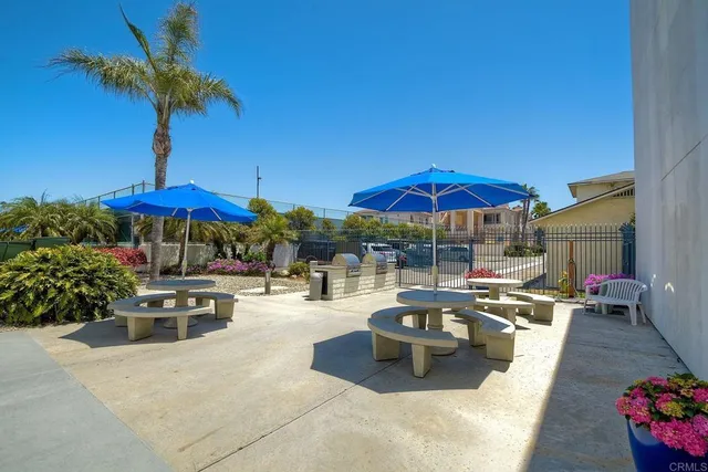 a view of pool with two chairs under an umbrella