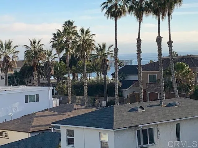 a view of a house with a backyard and palm trees