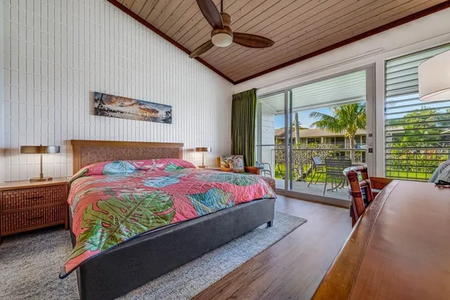 a bed sitting in a bedroom next to a large window