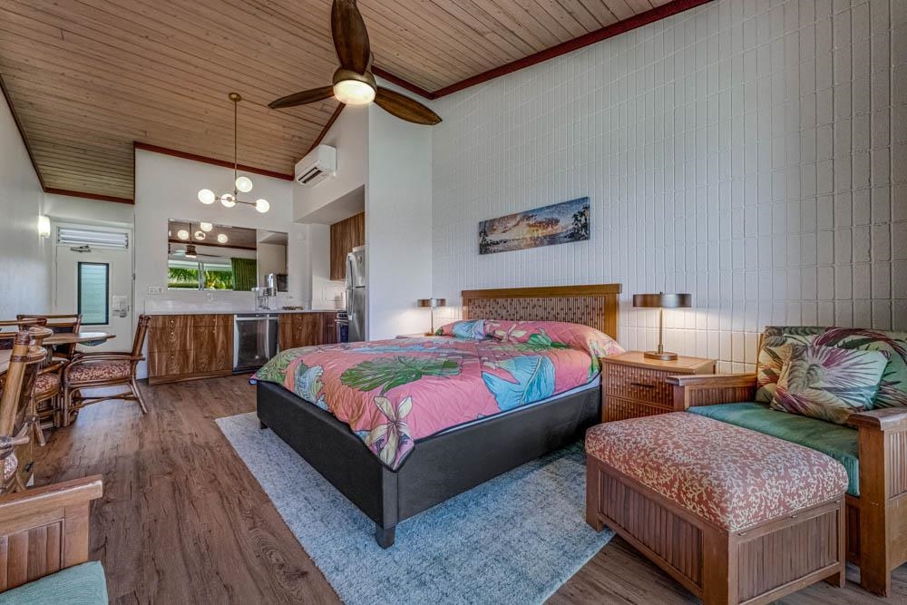 5315 Lower Honoapiilani Road, Unit C217 Lahaina, HI 96761 - Photo 3 of 26 a spacious bedroom with two beds and a chandelier