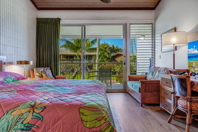 a bedroom with a bed and large window