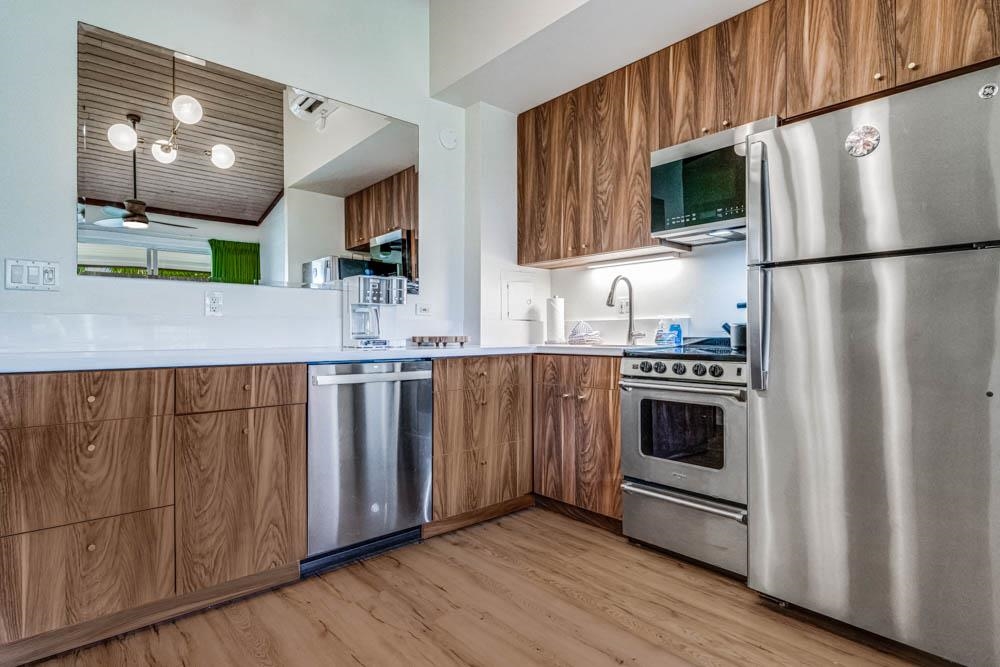 5315 Lower Honoapiilani Road, Unit C217 Lahaina, HI 96761 - Photo 7 of 26 a kitchen with granite countertop a refrigerator stove and microwave
