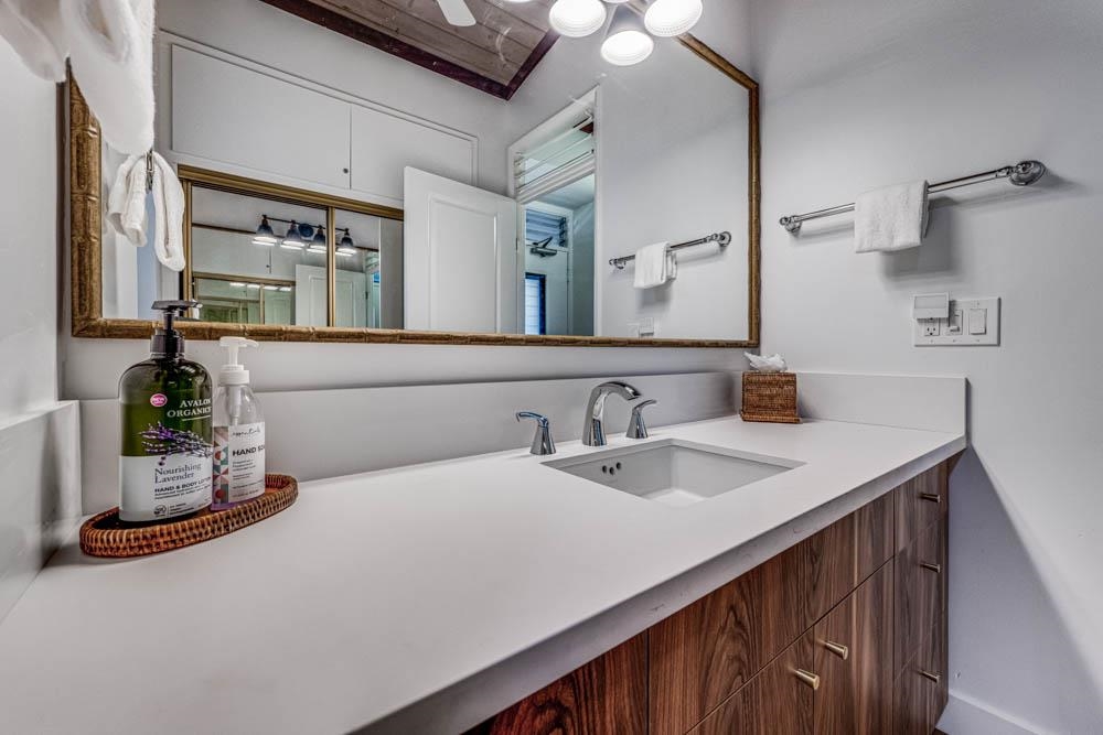 5315 Lower Honoapiilani Road, Unit C217 Lahaina, HI 96761 - Photo 10 of 26 a bathroom with a sink and a mirror