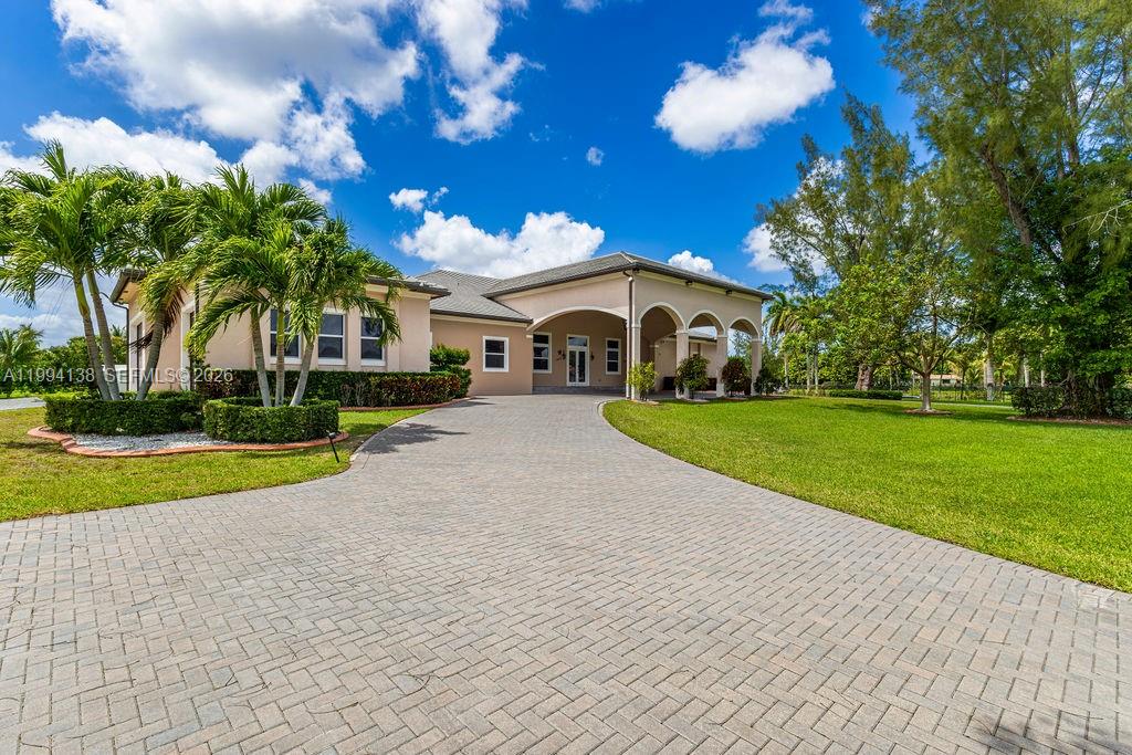 4800 Southwest 141st Avenue Miramar, FL 33027 - Photo 1 of 90 a view of a house with a big yard and potted plants