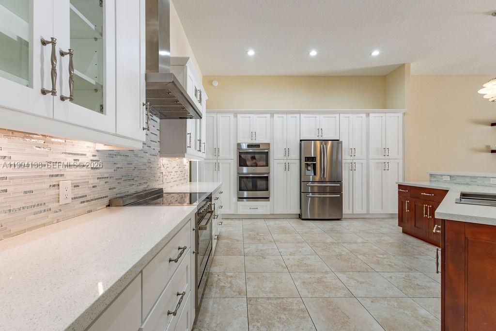 4800 Southwest 141st Avenue Miramar, FL 33027 - Photo 15 of 90 a kitchen with stainless steel appliances granite countertop a sink and cabinets