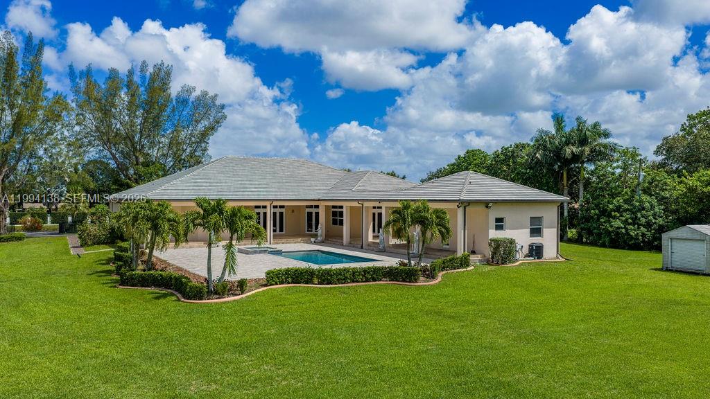 4800 Southwest 141st Avenue Miramar, FL 33027 - Photo 2 of 90 a front view of a house with a yard table and chairs