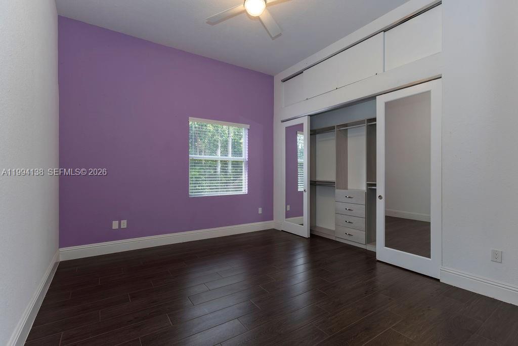 4800 Southwest 141st Avenue Miramar, FL 33027 - Photo 22 of 90 an empty room with wooden floor and windows