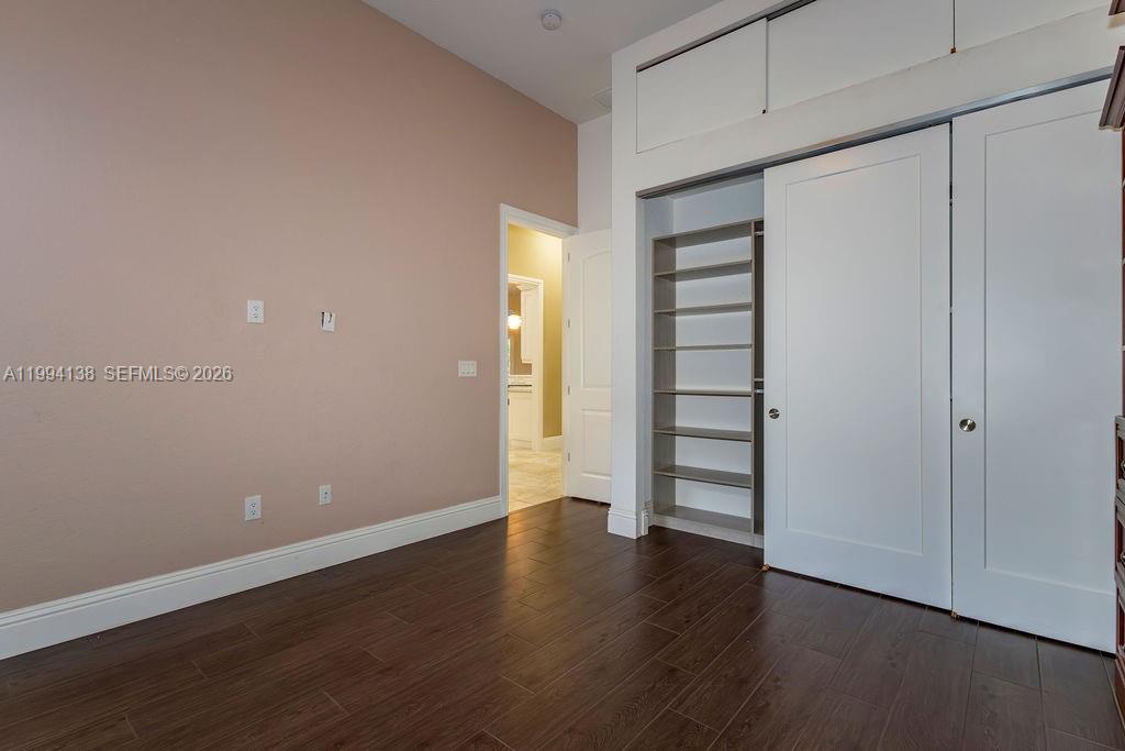 4800 Southwest 141st Avenue Miramar, FL 33027 - Photo 44 of 90 a view of an empty room with wooden floor and closet